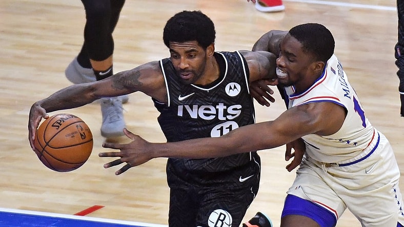 Apr 14, 2021; Philadelphia, Pennsylvania, USA; Brooklyn Nets guard Kyrie Irving (11) and Philadelphia 76ers guard Shake Milton (18) battle for the ball during the second quarter at Wells Fargo Center. Mandatory Credit: Eric Hartline-USA TODAY Sports