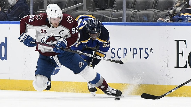 Apr 14, 2021; St. Louis, Missouri, USA; Colorado Avalanche left wing Gabriel Landeskog (92) checks St. Louis Blues left wing David Perron (57) during the first period at Enterprise Center. Mandatory Credit: Jeff Le-USA TODAY Sports