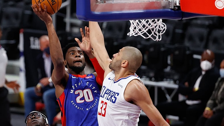 Apr 14, 2021; Detroit, Michigan, USA;  Detroit Pistons guard Josh Jackson (20) goes to the basket on LA Clippers forward Nicolas Batum (33) in the first half at Little Caesars Arena. Mandatory Credit: Rick Osentoski-USA TODAY Sports