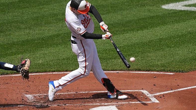 Apr 15, 2021; Baltimore, Maryland, USA; Baltimore Orioles outfielder Ryan Mountcastle (42) connects on a single in the first inning against the Seattle Mariners at Oriole Park at Camden Yards. Mandatory Credit: Mitch Stringer-USA TODAY Sports