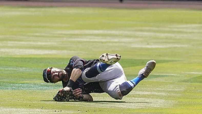 Apr 15, 2021; Cumberland, Georgia, USA; Miami Marlins second baseman Jon Berti (5) makes a running catch in shallow center field on a ball hit by Atlanta Braves second baseman Ozzie Albies (1) (not shown) during the second inning at Truist Park. Mandatory Credit: Dale Zanine-USA TODAY Sports
