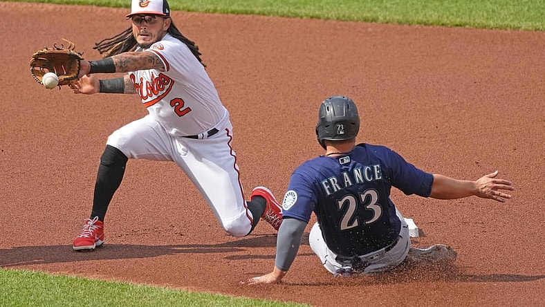 Apr 15, 2021; Baltimore, Maryland, USA; Seattle Mariners second baseman Ty France (23) slides into second base ahead of the throw to Baltimore Orioles shortstop Freddy Galvis (3) in the second inning at Oriole Park at Camden Yards. Mandatory Credit: Mitch Stringer-USA TODAY Sports