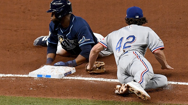Apr 15, 2021; St. Petersburg, Florida, USA; Tampa Bay Rays outfielder Manuel Margot (13) steals third base as Texas Rangers infielder Charlie Culberson (2) attempts to tag him in the fourth inning  at Tropicana Field. Mandatory Credit: Jonathan Dyer-USA TODAY Sports