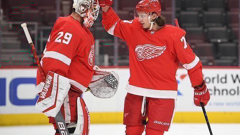 Apr 15, 2021; Detroit, Michigan, USA; Detroit Red Wings defenseman Troy Stecher (70) celebrates with goaltender Thomas Greiss (29) after the game against the Chicago Blackhawks at Little Caesars Arena. Mandatory Credit: Tim Fuller-USA TODAY Sports