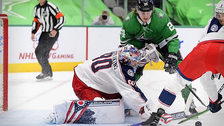 Apr 15, 2021; Dallas, Texas, USA; Columbus Blue Jackets goaltender Elvis Merzlikins (90) stops a shot by Dallas Stars left wing Roope Hintz (24) during the second period at the American Airlines Center. Mandatory Credit: Jerome Miron-USA TODAY Sports