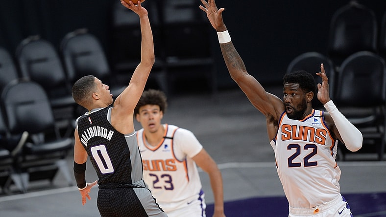 Apr 15, 2021; Phoenix, Arizona, USA; Sacramento Kings guard Tyrese Haliburton (0) shoots over Phoenix Suns center Deandre Ayton (22) during the second half at Phoenix Suns Arena. Mandatory Credit: Joe Camporeale-USA TODAY Sports