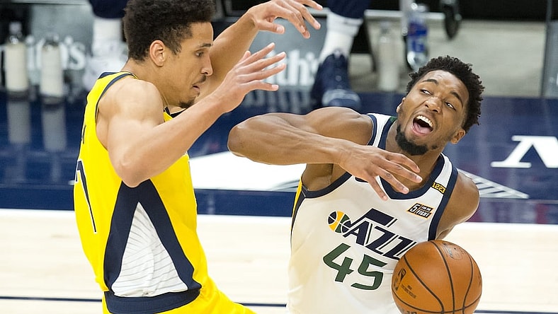 Apr 16, 2021; Salt Lake City, Utah, USA; Utah Jazz guard Donovan Mitchell (45) dribbles the ball against Indiana Pacers guard Malcolm Brogdon (7) during the first quarter at Vivint Smart Home Arena. Mandatory Credit: Russell Isabella-USA TODAY Sports