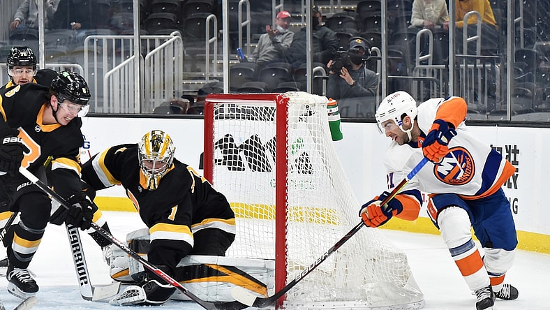 Apr 16, 2021; Boston, Massachusetts, USA; New York Islanders right wing Kyle Palmieri (21) tries to stuff the puck past Boston Bruins goaltender Jeremy Swayman (1) during the first period at TD Garden. Mandatory Credit: Bob DeChiara-USA TODAY Sports