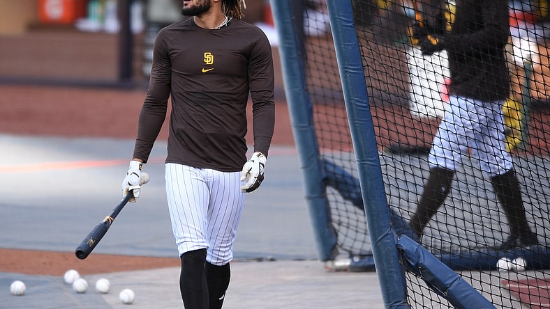 Apr 16, 2021; San Diego, California, USA; San Diego Padres shortstop Fernando Tatis Jr. (L) looks on during batting practice before the game against the Los Angeles Dodgers at Petco Park. Mandatory Credit: Orlando Ramirez-USA TODAY Sports