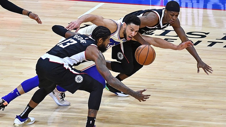Apr 16, 2021; Philadelphia, Pennsylvania, USA; Philadelphia 76ers guard Ben Simmons (25) dives for loose ball with LA Clippers guard Paul George (13) and guard Rajon Rondo (4) during the second quarter at Wells Fargo Center. Mandatory Credit: Eric Hartline-USA TODAY Sports