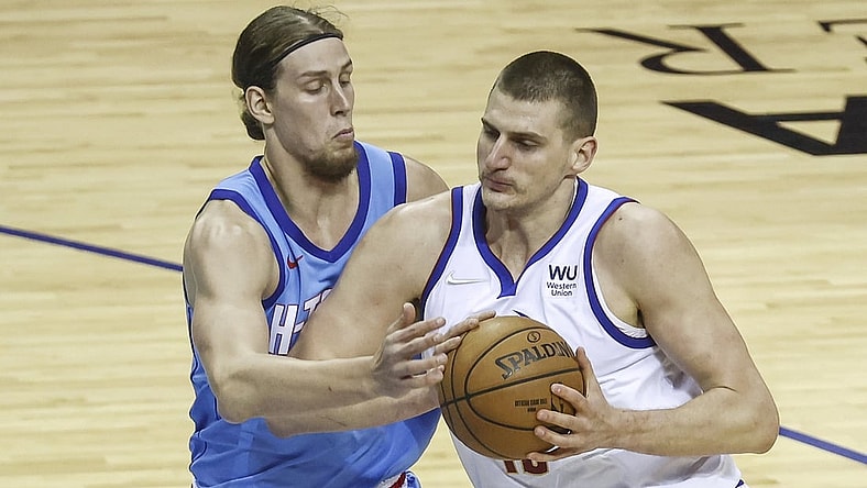 Apr 16, 2021; Houston, Texas, USA; Denver Nuggets center Nikola Jokic (15) drives with the ball as Houston Rockets forward Kelly Olynyk (41) defends during the first quarter at Toyota Center. Mandatory Credit: Troy Taormina-USA TODAY Sports