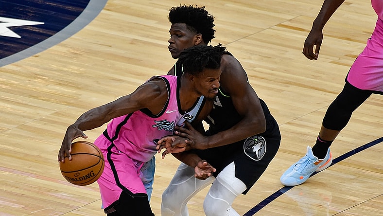 Apr 16, 2021; Minneapolis, Minnesota, USA; Miami Heat forward Jimmy Butler (22) handles the ball while defended by Minnesota Timberwolves forward Anthony Edwards (1) during the first quarter at Target Center. Mandatory Credit: Jeffrey Becker-USA TODAY Sports