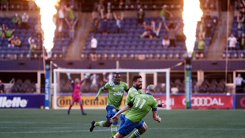 Apr 16, 2021; Seattle, Washington, USA; Seattle Sounders FC teammates celebrate a goal by midfielder Joao Paulo (6) against the Minnesota United FC during the second half at Lumen Field. Mandatory Credit: Jennifer Buchanan-USA TODAY Sports