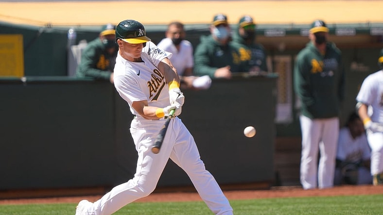 Apr 17, 2021; Oakland, California, USA;  Oakland Athletics third baseman Matt Chapman (26) hits a RBI single during the fifth inning against the Detroit Tigers at RingCentral Coliseum. Mandatory Credit: Stan Szeto-USA TODAY Sports