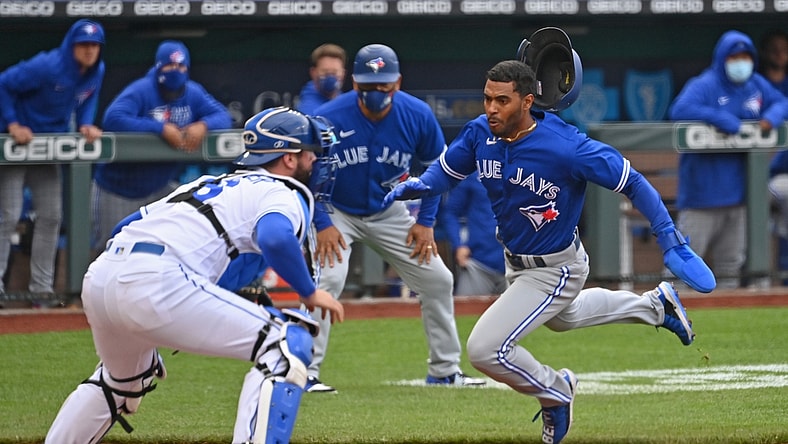 Apr 17, 2021; Kansas City, Missouri, USA;  Toronto Blue Jays right fielder Josh Palacios (77) scores a run past Kansas City Royals catcher Cam Gallagher (36) during the second inning at Kauffman Stadium. Mandatory Credit: Peter Aiken-USA TODAY Sports