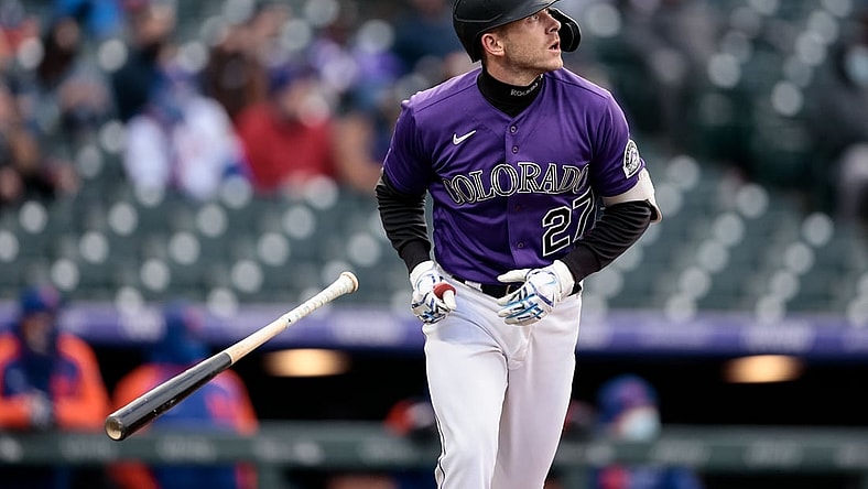 Apr 17, 2021; Denver, Colorado, USA; Colorado Rockies shortstop Trevor Story (27) watches his ball on a sacrifice fly RBI in the first inning against the New York Mets at Coors Field. Mandatory Credit: Isaiah J. Downing-USA TODAY Sports