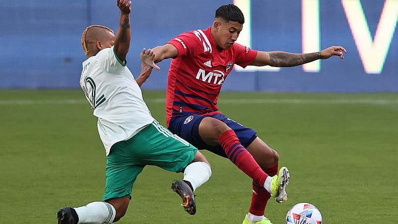 Apr 17, 2021; Frisco, Texas, USA; Colorado Rapids forward Michael Barrios (12) fights to control the ball against FC Dallas defender Jose Martinez (3) at Toyota Stadium. Mandatory Credit: Matthew Emmons-USA TODAY Sports
