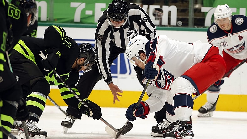 Apr 17, 2021; Dallas, Texas, USA; Dallas Stars center Andrew Cogliano (11) and Columbus Blue Jackets center Jack Roslovic (96) in a face off in the second period  at American Airlines Center. Mandatory Credit: Tim Heitman-USA TODAY Sports