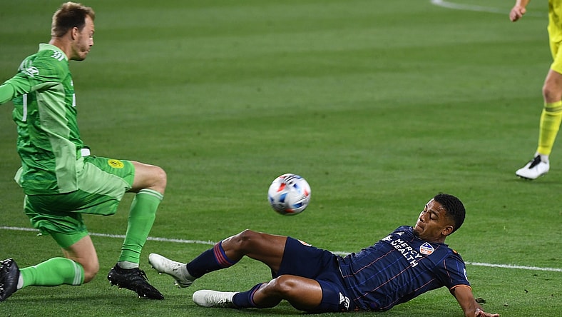 Apr 17, 2021; Nashville, TN, Nashville, TN, USA; Nashville SC goalkeeper Joe Willis (1) kicks the ball away from FC Cincinnati attacker Brenner (9) during the second half at Nissan Stadium. Mandatory Credit: Christopher Hanewinckel-USA TODAY Sports