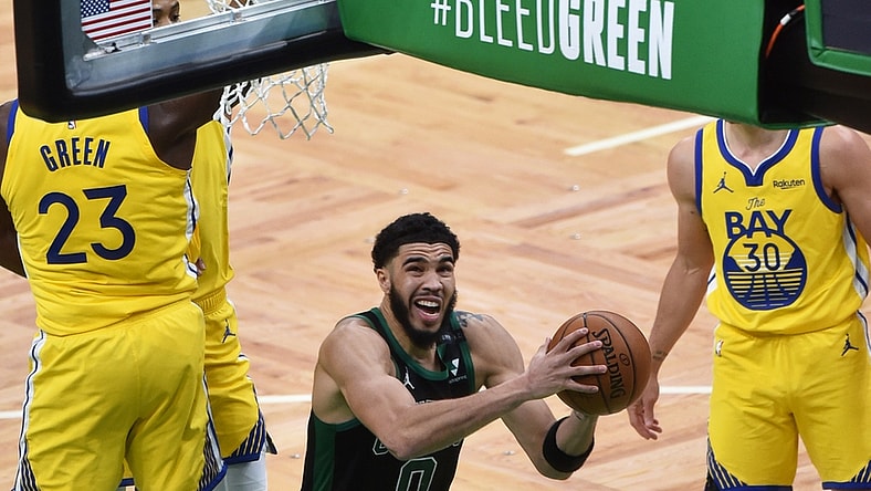 Apr 17, 2021; Boston, Massachusetts, USA;  Boston Celtics forward Jayson Tatum (0) drives to the basket for two points past Golden State Warriors forward Draymond Green (23) during the second half at TD Garden. Mandatory Credit: Bob DeChiara-USA TODAY Sports