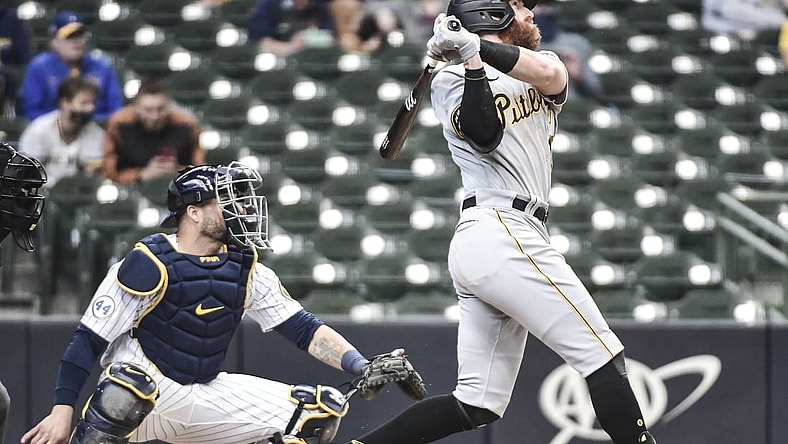 Apr 18, 2021; Milwaukee, Wisconsin, USA; Pittsburgh Pirates third baseman Colin Moran (19) hits a three-run home run in the third inning as Milwaukee Brewers catcher Manny Pina (9) watches at American Family Field. Mandatory Credit: Benny Sieu-USA TODAY Sports