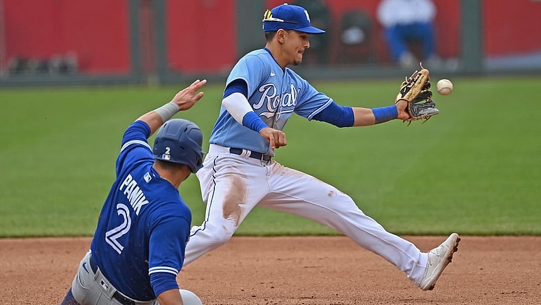 Apr 18, 2021; Kansas City, Missouri, USA; Kansas City Royals shortstop Nicky Lopez (8) forces out Toronto Blue Jays third baseman Joe Panik (2) at second base during the fourth inning at Kauffman Stadium. Mandatory Credit: Peter Aiken-USA TODAY Sports