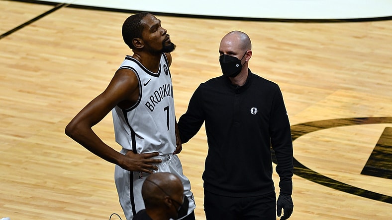 Apr 18, 2021; Miami, Florida, USA; Brooklyn Nets forward Kevin Durant (7) gets examined off the court during the first half of a game against the Miami Heat at American Airlines Arena. Mandatory Credit: Jim Rassol-USA TODAY Sports