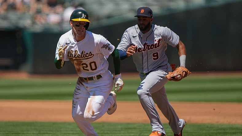 Apr 18, 2021; Oakland, California, USA;  Oakland Athletics left fielder Mark Canha (20) is chased by Detroit Tigers shortstop Willi Castro (9) during the first inning at RingCentral Coliseum. Mandatory Credit: Stan Szeto-USA TODAY Sports