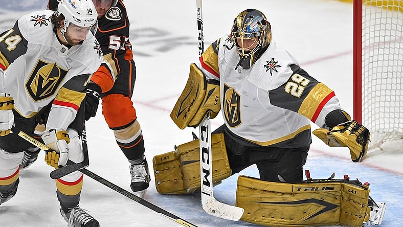 Apr 18, 2021; Anaheim, California, USA; Vegas Golden Knights goaltender Marc-Andre Fleury (29) defends the net as Vegas Golden Knights defenseman Nicolas Hague (14) knocks away a shot on goal by Anaheim Ducks center Adam Henrique (14) in the third period of the game at Honda Center. Mandatory Credit: Jayne Kamin-Oncea-USA TODAY Sports
