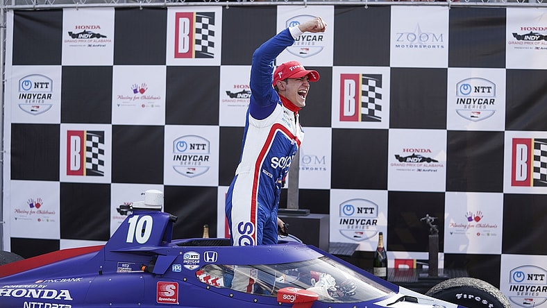Apr 18, 2021; Birmingham, Alabama, USA; Indy driver Alex Palou (10) reacts as he climbs out of the car after winning at Barber Motorsports Park. Mandatory Credit: Marvin Gentry-USA TODAY Sports