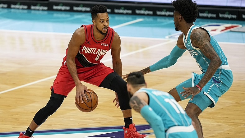 Apr 18, 2021; Charlotte, North Carolina, USA; Portland Trail Blazers guard CJ McCollum (3) brings the ball upourt defended by Charlotte Hornets forward Jalen McDaniels (6) during the first quarter at the Spectrum Center. Mandatory Credit: Jim Dedmon-USA TODAY Sports