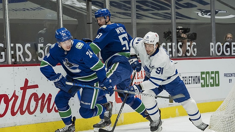 Apr 18, 2021; Vancouver, British Columbia, CAN; Vancouver Canucks forward Jimmy Vesey (24) checks Toronto Maple Leafs forward John Tavares (91) in the first period at Rogers Arena. Mandatory Credit: Bob Frid-USA TODAY Sports