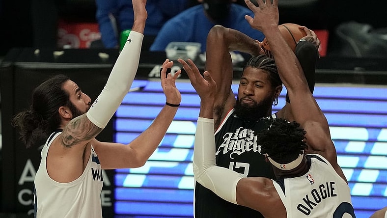 Apr 18, 2021; Los Angeles, California, USA; LA Clippers guard Paul George (13) is defended by Minnesota Timberwolves center Naz Reid (11) and forward Josh Okogie (20) in the first half at Staples Center. Mandatory Credit: Kirby Lee-USA TODAY Sports