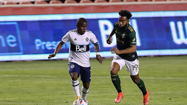 Apr 18, 2021; Sandy, Utah, USA; Vancouver Whitecaps FC forward Deiber Caicedo (7) plays the ball while defended by Portland Timbers midfielder Eryk Williamson (19) during the first half at Rio Tinto Stadium. Mandatory Credit: Rob Gray-USA TODAY Sports