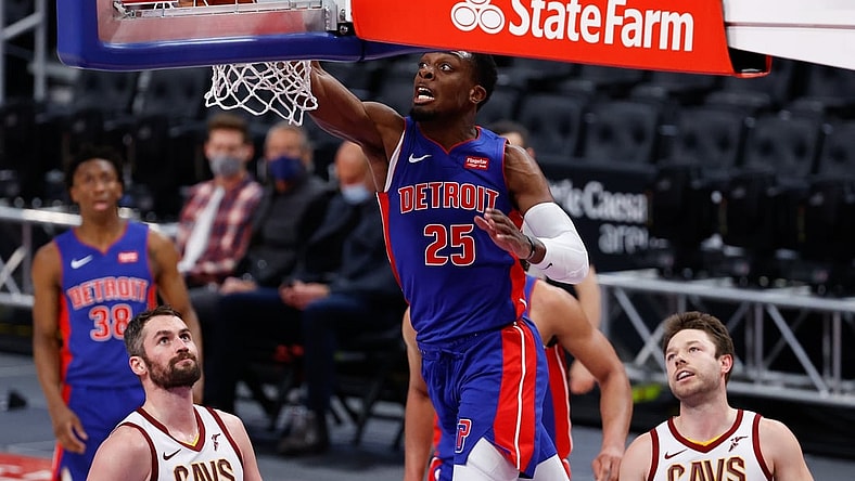 Apr 19, 2021; Detroit, Michigan, USA;  Detroit Pistons forward Tyler Cook (25) dunks on Cleveland Cavaliers forward Kevin Love (0) and guard Matthew Dellavedova (18) in the first half at Little Caesars Arena. Mandatory Credit: Rick Osentoski-USA TODAY Sports