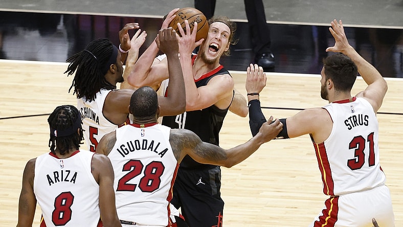 Apr 19, 2021; Miami, Florida, USA;  Houston Rockets forward Kelly Olynyk (41) is defended by Miami Heat players forward Precious Achiuwa (5), forward Trevor Arizam guard Andre Iguodada and guard Max Straus (31) during the first half at American Airlines Arena. Mandatory Credit: Rhona Wise-USA TODAY Sports
