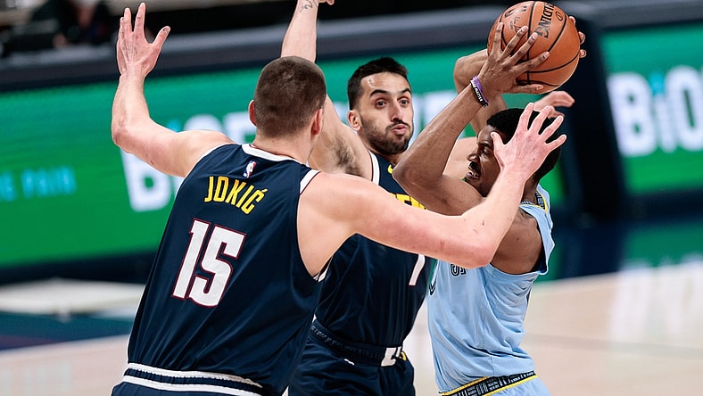 Apr 19, 2021; Denver, Colorado, USA; Memphis Grizzlies guard De'Anthony Melton (0) looks to pass the ball under pressure from Denver Nuggets center Nikola Jokic (15) and guard Facundo Campazzo (7) in the first quarter at Ball Arena. Mandatory Credit: Isaiah J. Downing-USA TODAY Sports