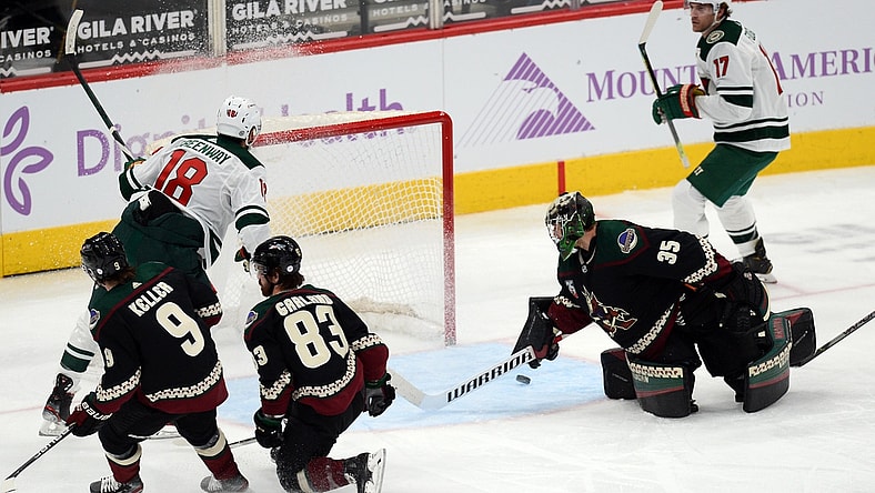 Apr 19, 2021; Glendale, Arizona, USA; Minnesota Wild left wing Jordan Greenway (18) scores a goal against Arizona Coyotes goaltender Darcy Kuemper (35) during the second period at Gila River Arena. Mandatory Credit: Joe Camporeale-USA TODAY Sports
