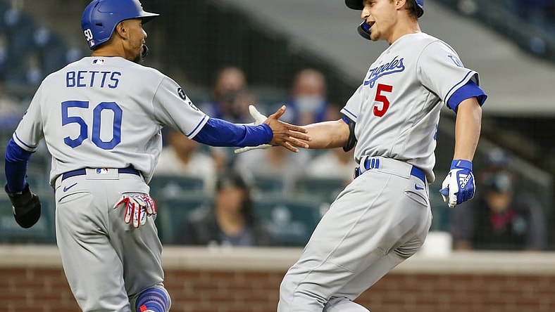 Apr 19, 2021; Seattle, Washington, USA; Los Angeles Dodgers shortstop Corey Seager (5) greets center fielder Mookie Betts (50) after hitting a two-run home run against the Seattle Mariners during the third inning at T-Mobile Park. Betts scored a run on the hit. Mandatory Credit: Joe Nicholson-USA TODAY Sports