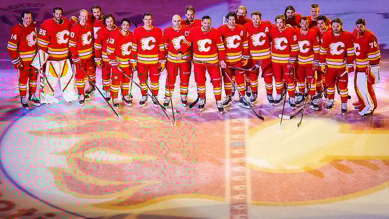 Apr 19, 2021; Calgary, Alberta, CAN; Calgary Flames left wing Milan Lucic (17) poses for a photo with teammates as he was honored for his 1000 NHL hockey game prior to the game between the Calgary Flames and the Ottawa Senators at Scotiabank Saddledome. Mandatory Credit: Sergei Belski-USA TODAY Sports