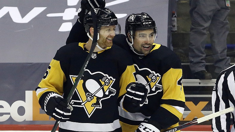 Apr 20, 2021; Pittsburgh, Pennsylvania, USA;  Pittsburgh Penguins defenseman Mike Matheson (5) celebrates with defenseman Cody Ceci (4) after scoring a goal against the New Jersey Devils during the first period at PPG Paints Arena. Mandatory Credit: Charles LeClaire-USA TODAY Sports