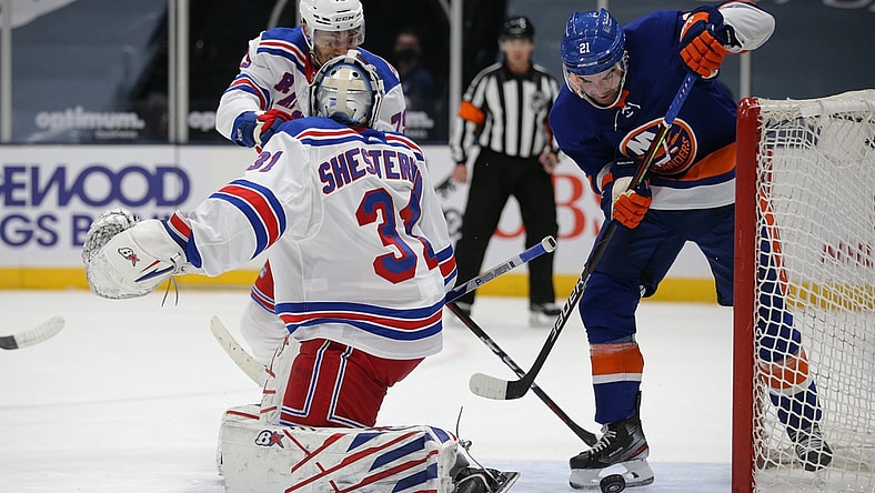 Apr 20, 2021; Uniondale, New York, USA; New York Islanders right wing Kyle Palmieri (21) plays the puck against New York Rangers goalie Igor Shesterkin (31) and defenseman K'Andre Miller (79) during the first period at Nassau Veterans Memorial Coliseum. Mandatory Credit: Brad Penner-USA TODAY Sports