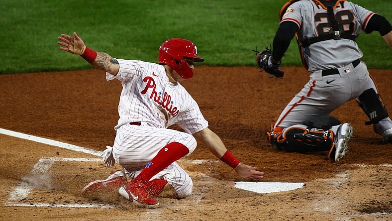 Apr 20, 2021; Philadelphia, Pennsylvania, USA; Philadelphia Phillies center fielder Mickey Moniak (16) slides past San Francisco Giants catcher Buster Posey (28) to score a run in the second inning at Citizens Bank Park. Mandatory Credit: Kyle Ross-USA TODAY Sports