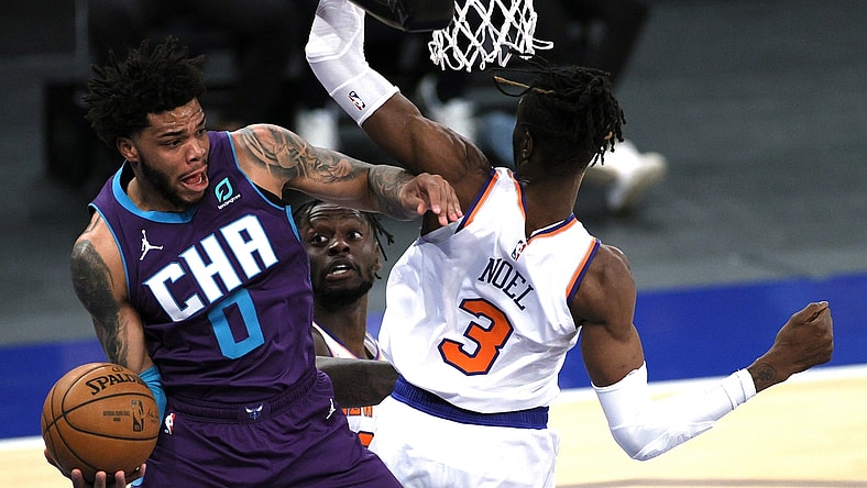 Apr 20, 2021; New York, New York, USA;  Miles Bridges #0 of the Charlotte Hornets looks to pass as Julius Randle #30 and Nerlens Noel #3 of the New York Knicks defend during the first half at Madison Square Garden. Mandatory Credit:  Sarah Stier/POOL PHOTOS-USA TODAY Sports