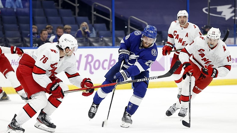 Apr 20, 2021; Tampa, Florida, USA; Tampa Bay Lightning center Blake Coleman (20) shoots as Carolina Hurricanes defenseman Brady Skjei (76) defends during the first period at Amalie Arena. Mandatory Credit: Kim Klement-USA TODAY Sports