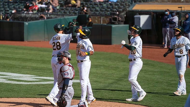 Apr 20, 2021; Oakland, California, USA;  Oakland Athletics first baseman Matt Olson (28) celebrates after hitting a grand slam home run with Oakland Athletics shortstop Elvis Andrus (17) and teammates during the fourth inning |T at RingCentral Coliseum. Mandatory Credit: Neville E. Guard-USA TODAY Sports