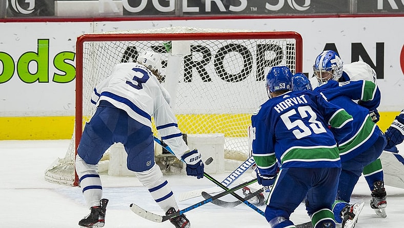 Apr 20, 2021; Vancouver, British Columbia, CAN; Vancouver Canucks forward Tanner Pearson (70) scores on Toronto Maple Leafs goalie David Rittich (33) as Maple Leafs defenseman Justin Holl (3) looks on in the third period at Rogers Arena. Canucks won 6-3. Mandatory Credit: Bob Frid-USA TODAY Sports
