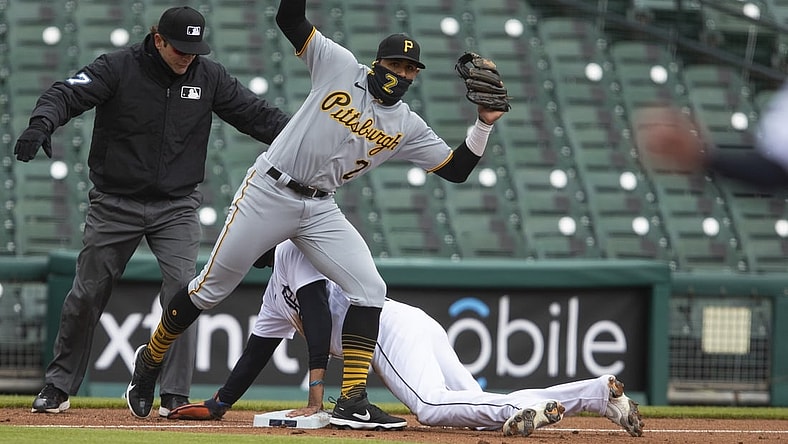 Apr 21, 2021; Detroit, Michigan, USA; Detroit Tigers right fielder Victor Reyes (22) slides safely into third base against Pittsburgh Pirates second baseman Erik Gonzalez (2) during the third inning at Comerica Park. Mandatory Credit: Raj Mehta-USA TODAY Sports