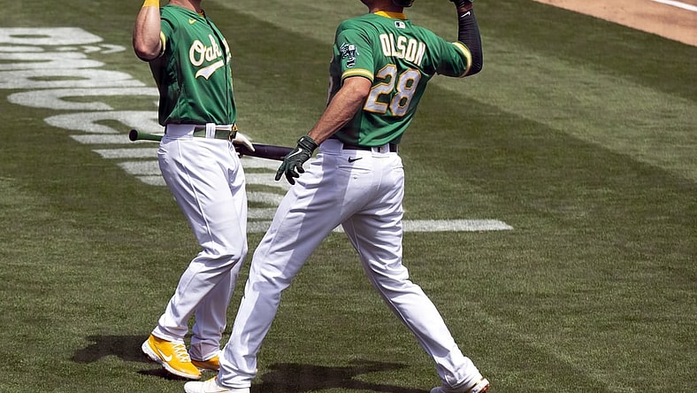 Apr 21, 2021; Oakland, California, USA; Oakland Athletics Matt Olson (28) gets an elbow bash from teammate Matt Chapman after hitting a solo home run against the Minnesota Twins during the second inning of a Major League Baseball game at RingCentral Coliseum. Mandatory Credit: D. Ross Cameron-USA TODAY Sports