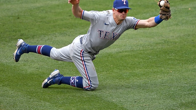 Apr 21, 2021; Anaheim, California, USA;  Texas Rangers second baseman Nick Solak (15) catches a line drive hit by Los Angeles Angels shortstop Jose Iglesias (4) for the final out of the fourth the first inning of the game at Angel Stadium. Mandatory Credit: Jayne Kamin-Oncea-USA TODAY Sports
